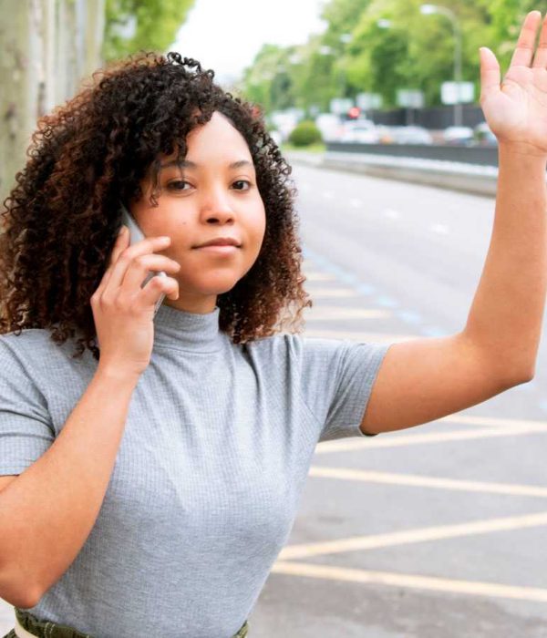Girl raises her hand to call an Uber